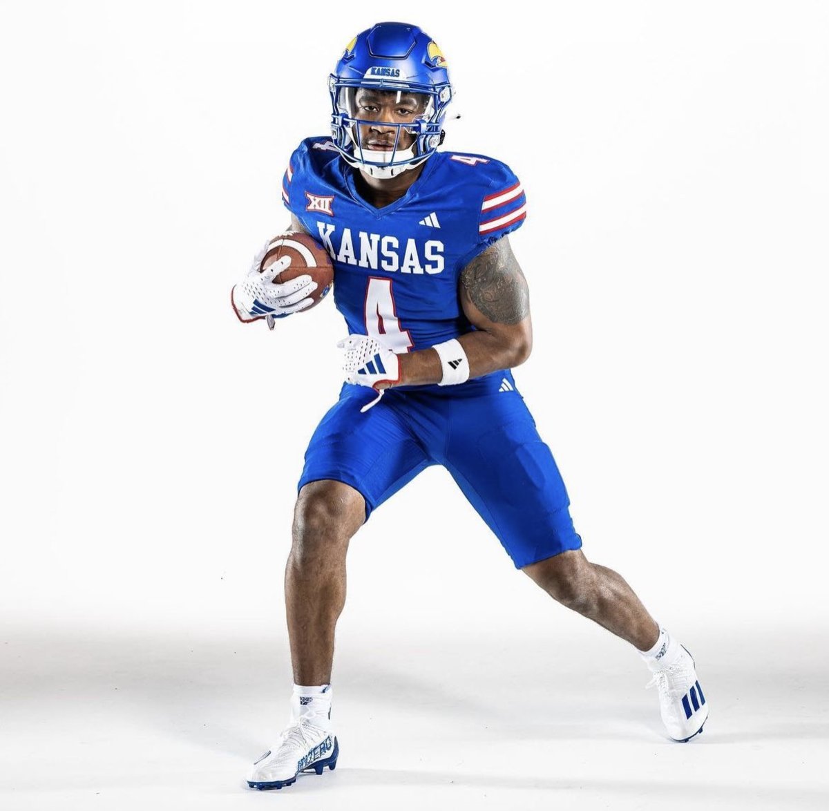 Devin Neal wears the new blue uniforms unveiled by the Kansas Jayhawks on July 10, 2023.